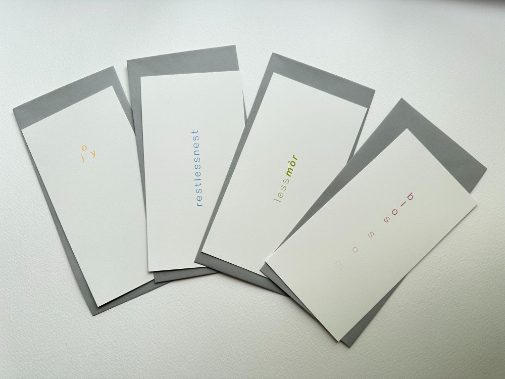 Image of four postcards containing minimalist poems.