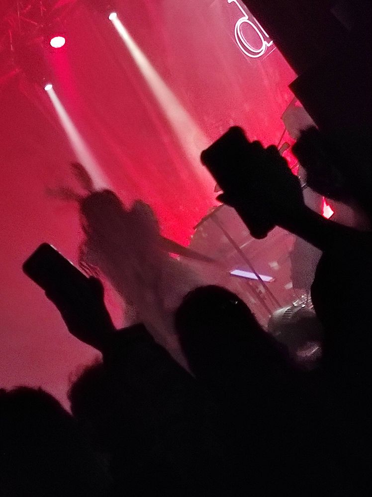 Blurry pic of Dodie dancing about on stage