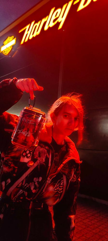 tgirl from earlier photos wearing same clothes holding up a hguc marasai contained in a plastic hardcase with her fuckfinger