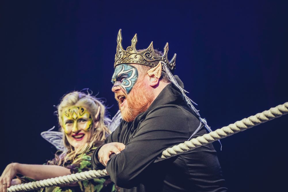 The fairy king speaks in BSL to the audience, with his sidekick Puck as translator stood next to him