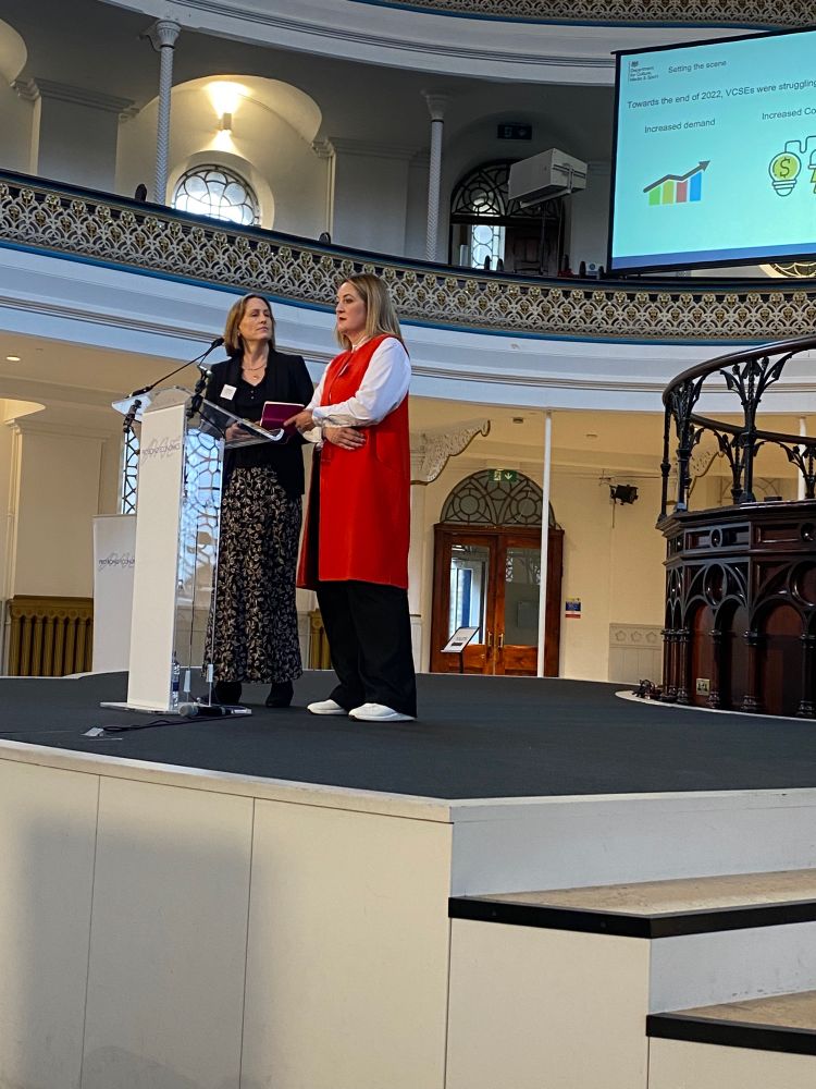 Two women at a lectern 