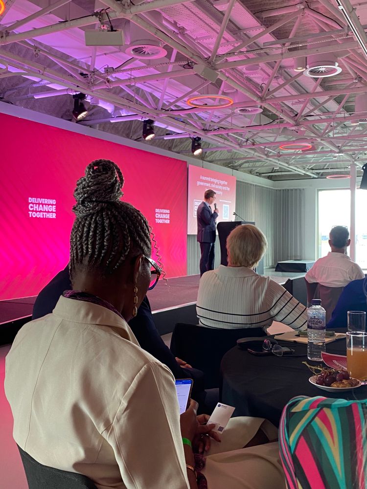 Man on stage delivering speech 