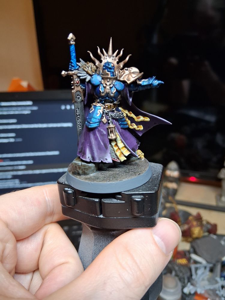 Lord Terminos with greatsword. Cobalt armoured warrior with muted gold trim and purple robes