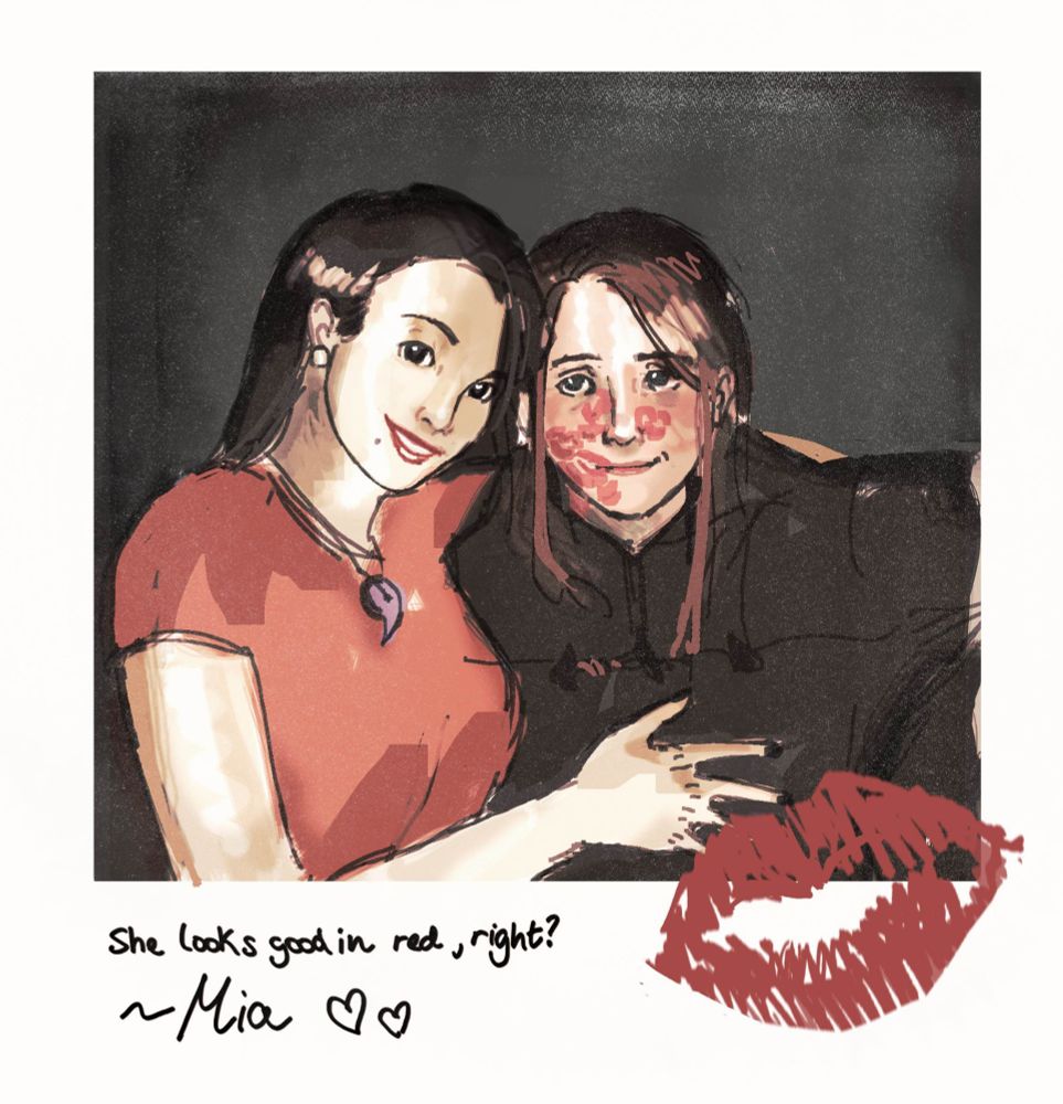An illustration designed to look like a printed flash photograph of Mia Fey and Lana Skye from Ace Attorney. Mia looks at the camera, and Lana looks at Mia. Lana's face is covered in red lipstick marks. Beneath the picture, text (written by Mia) reads "She looks good in red, right? ~Mia" followed by two little drawn hearts. To the right , slightly overlapping the picture, is a red lipstick kiss mark. 