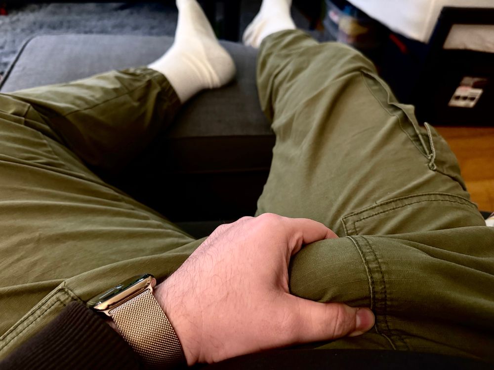 Holding a thick bulge in green jogger pants and white socks. Just a little bit stoned