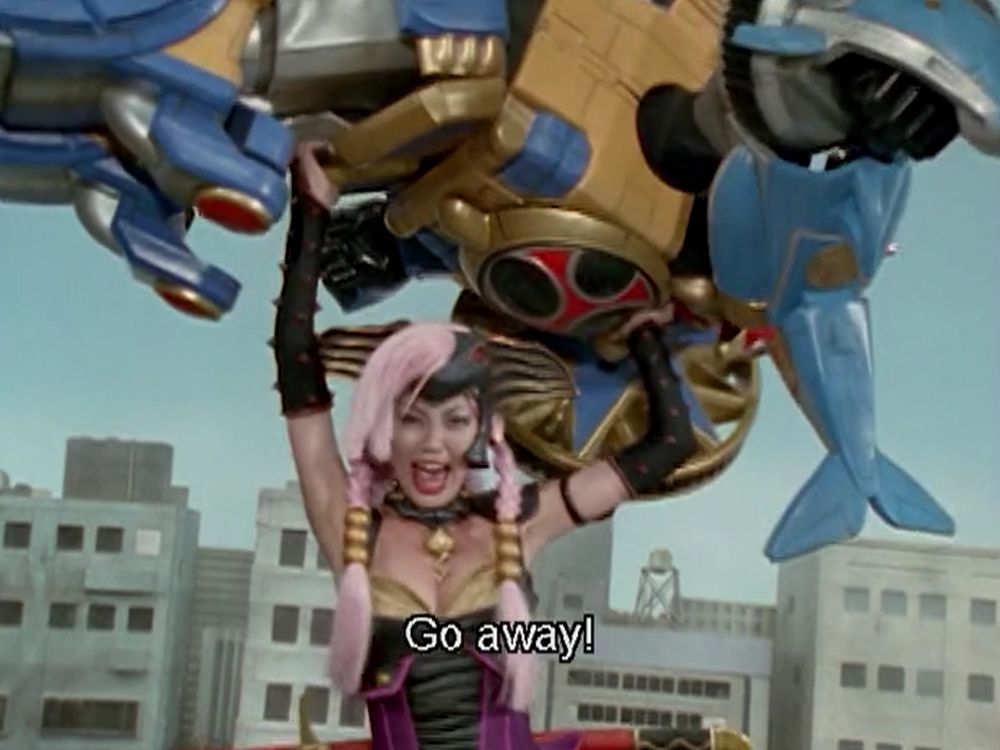 A giant Wendinu picking up the Hurricaneger's giant robot and throwing it yelling "GO AWAY"