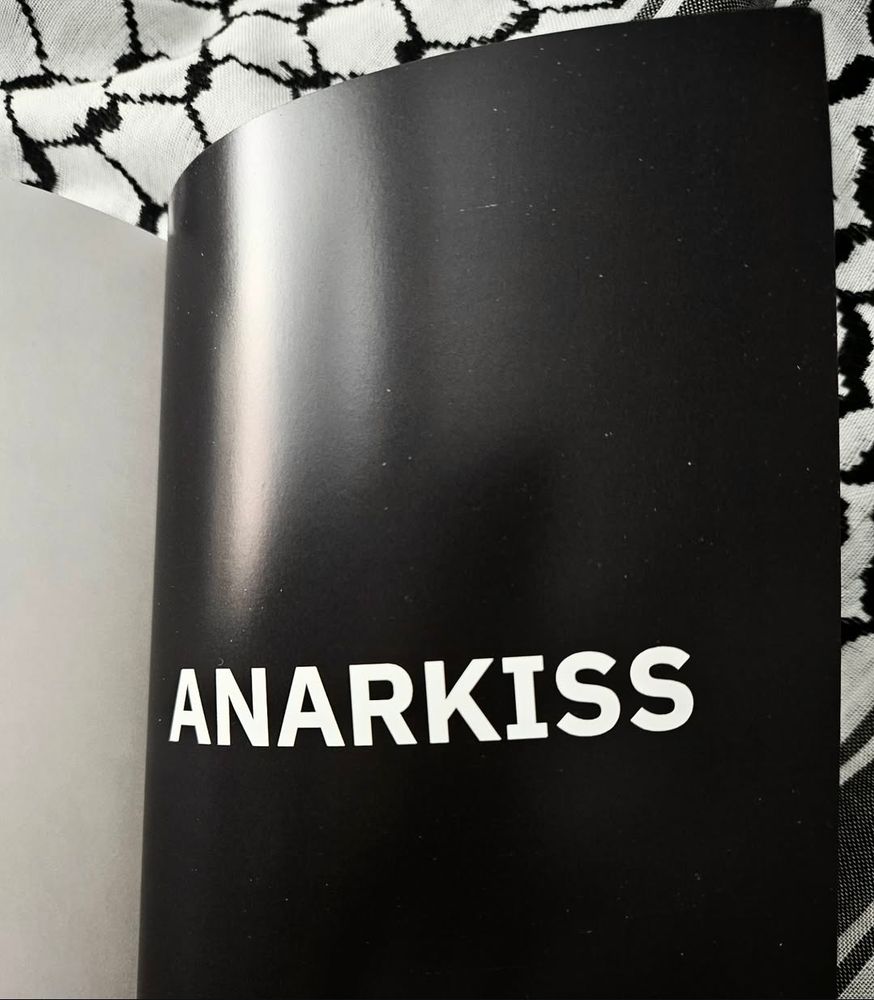 Last page of the zine reading ANARKISS in bold white letters on a black page. The black and white Kufyia makes for the background again.