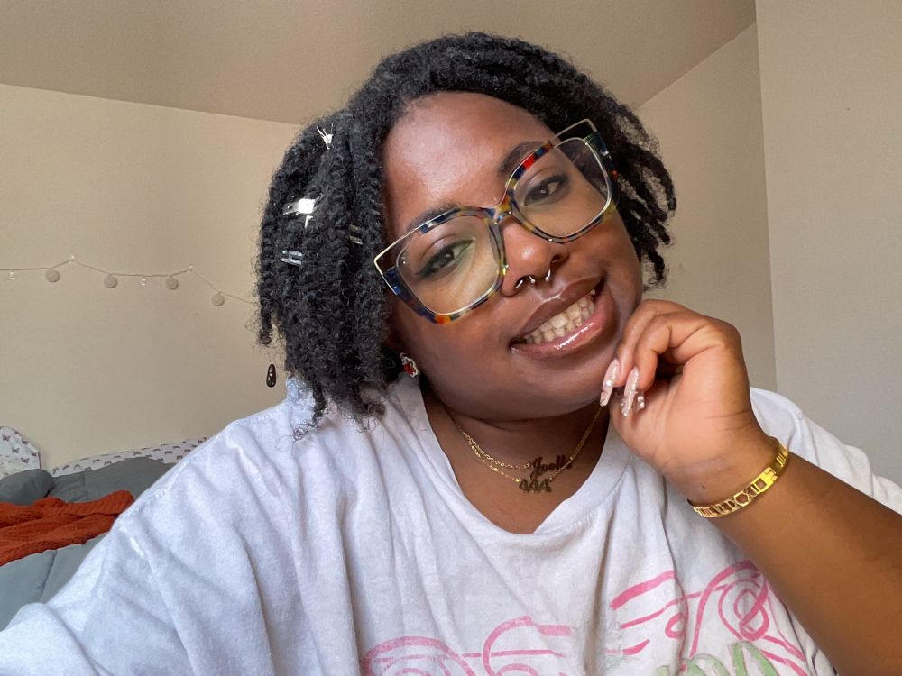 Me posed for a selfie in glasses. 