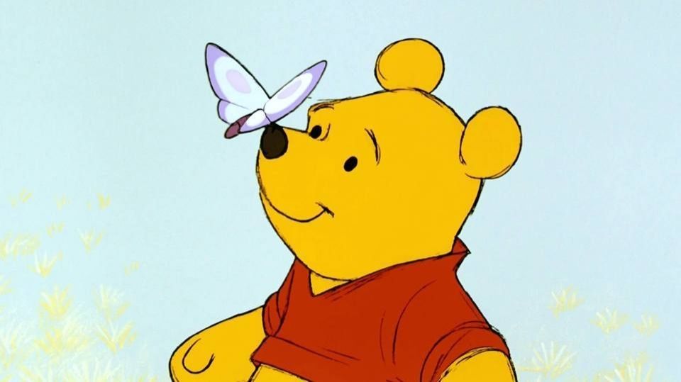 Winnie the Pooh with a butterfly on his nose