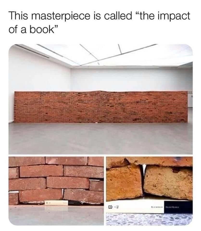 Art exhibit featuring a brick wall with a single book on the bottom altering the shape of the wall 