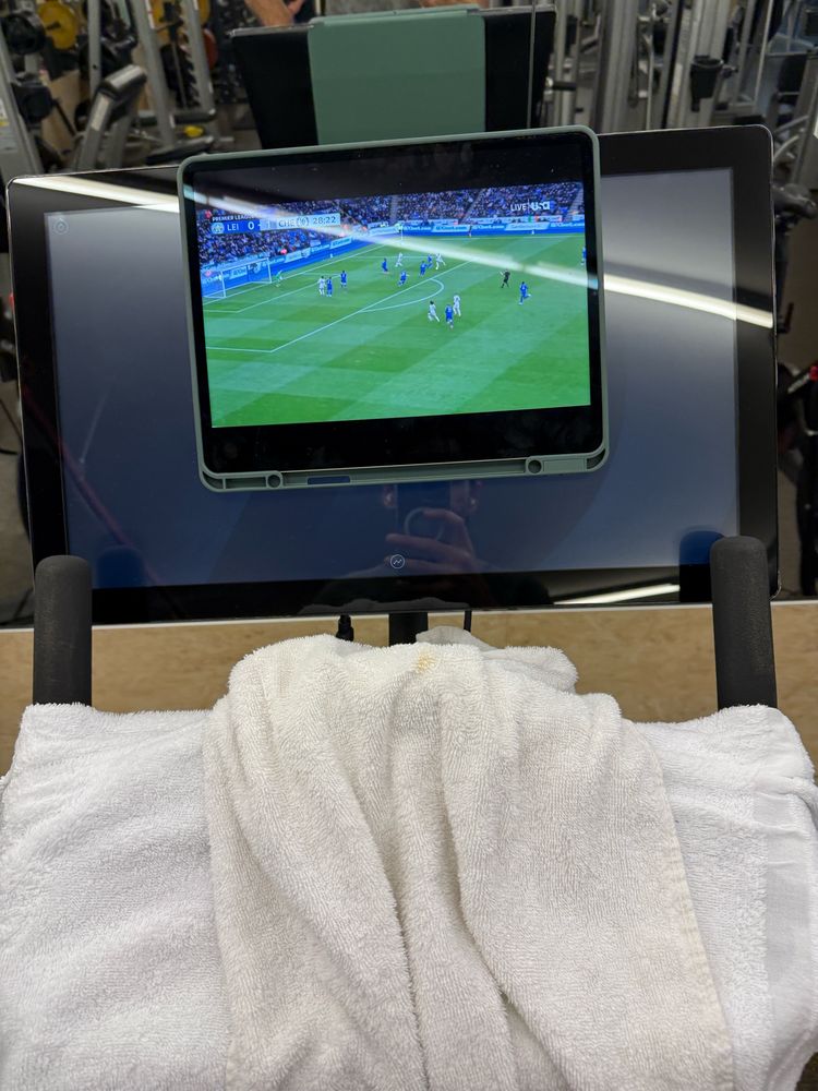 POV riding peloton watching EPL on iPad. 