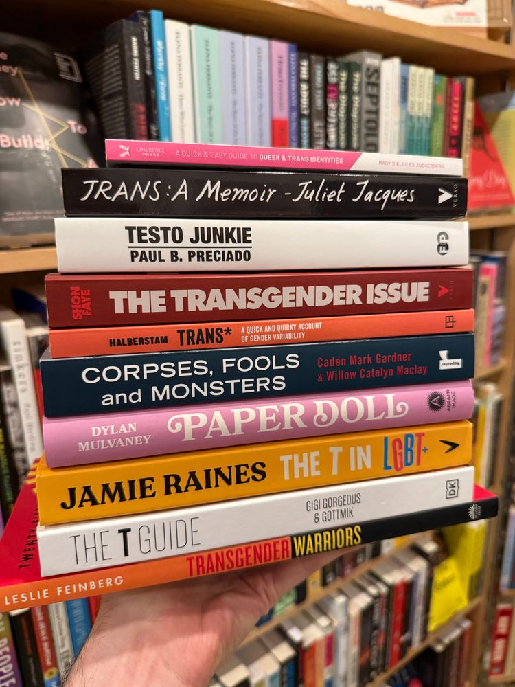 a stack of books about trans issues and/or by trans authors 