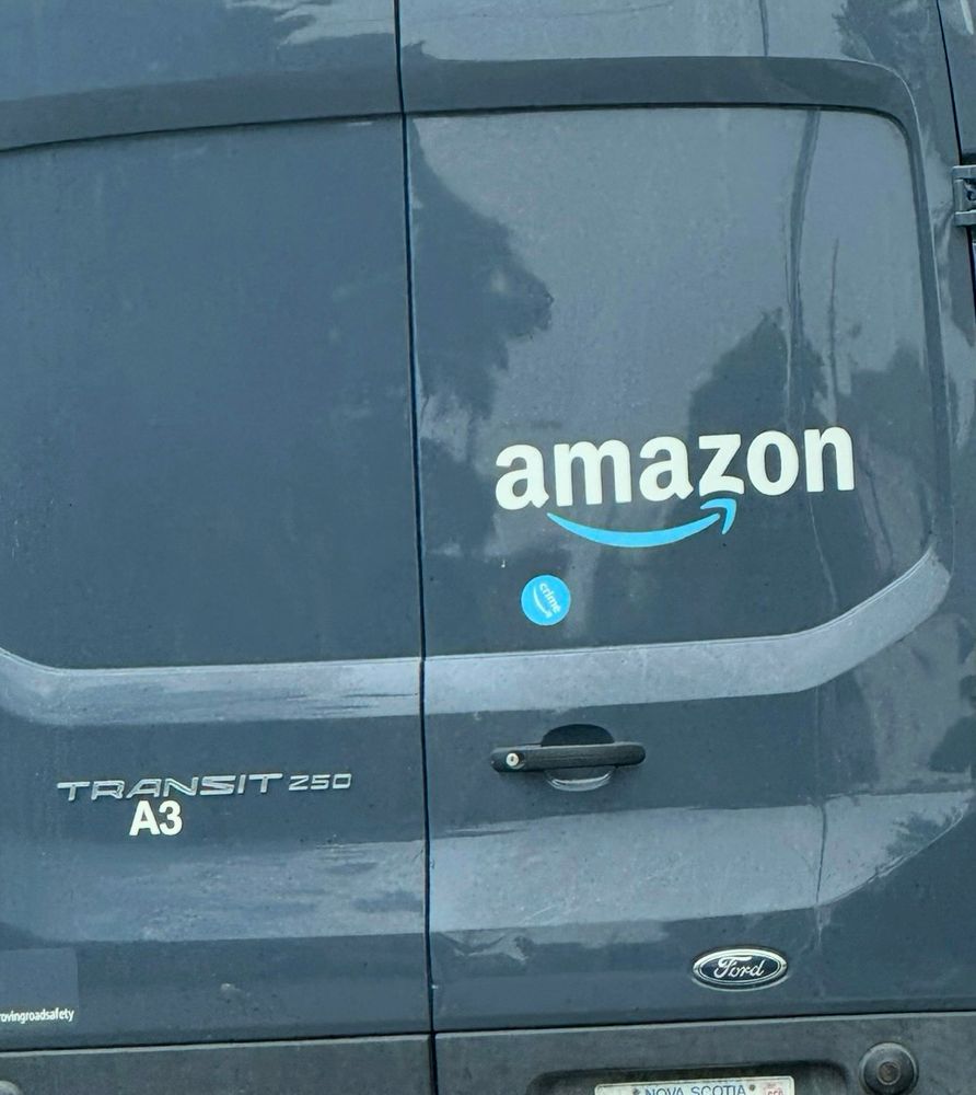 an amazon van with an amazon crime sticker on it
