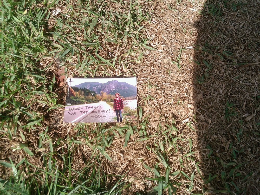 A photo of a man named Carl in front of the iconic mountains from the Twin Peaks title sequence. It says “David - thanks for the journey! -Carl”