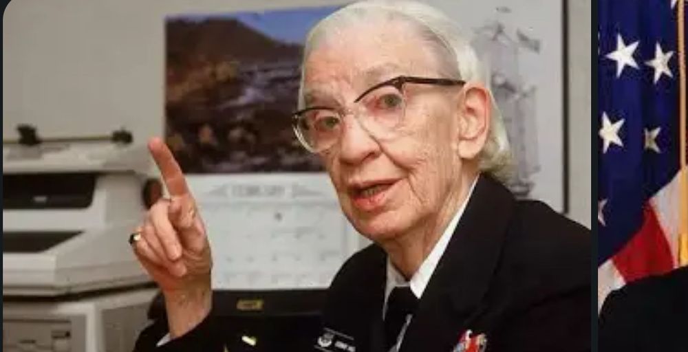 A photo of a white elderly female in glasses - Rear Admiral Grace Hopper. Now go look up everything about her and fall in love with this wonderful certifiable badass. 