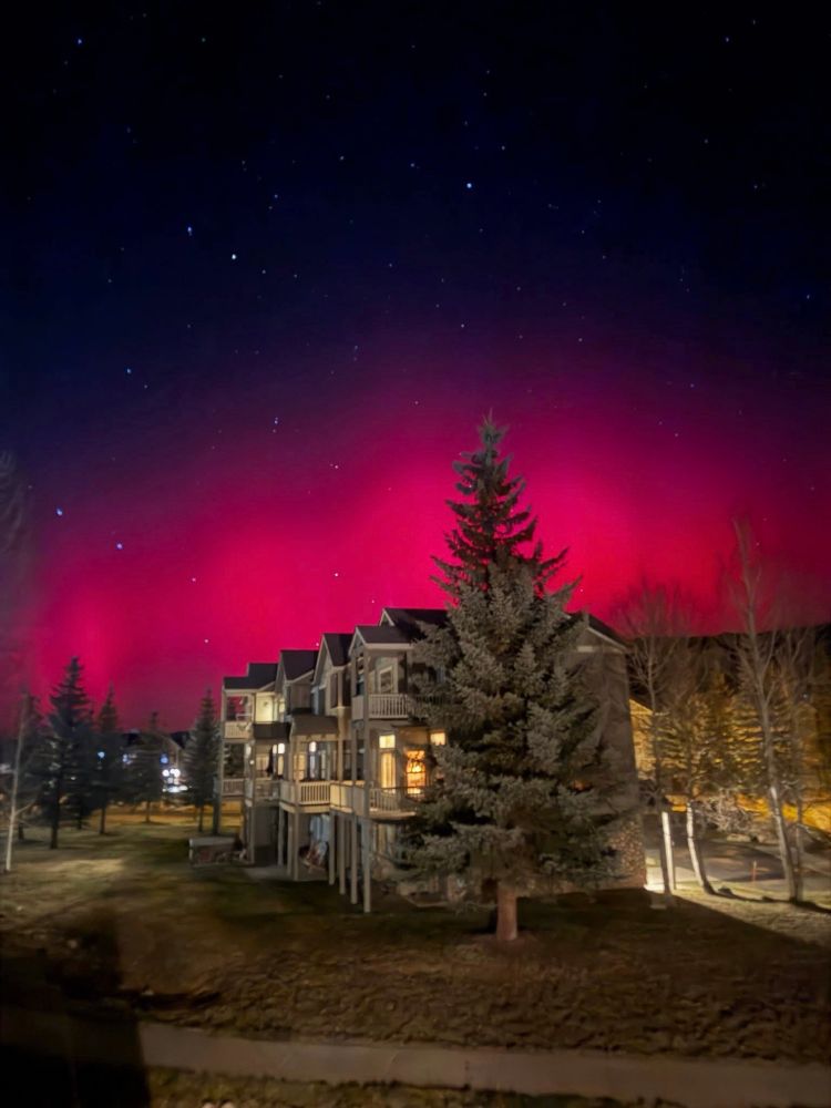 Magenta aurora with condos in foreground 