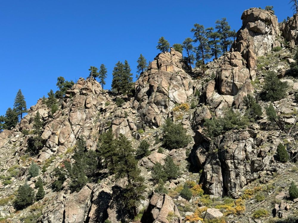 Weathered granite rocks withe scattered pines

The saturation has not been adjusted, it was this blue