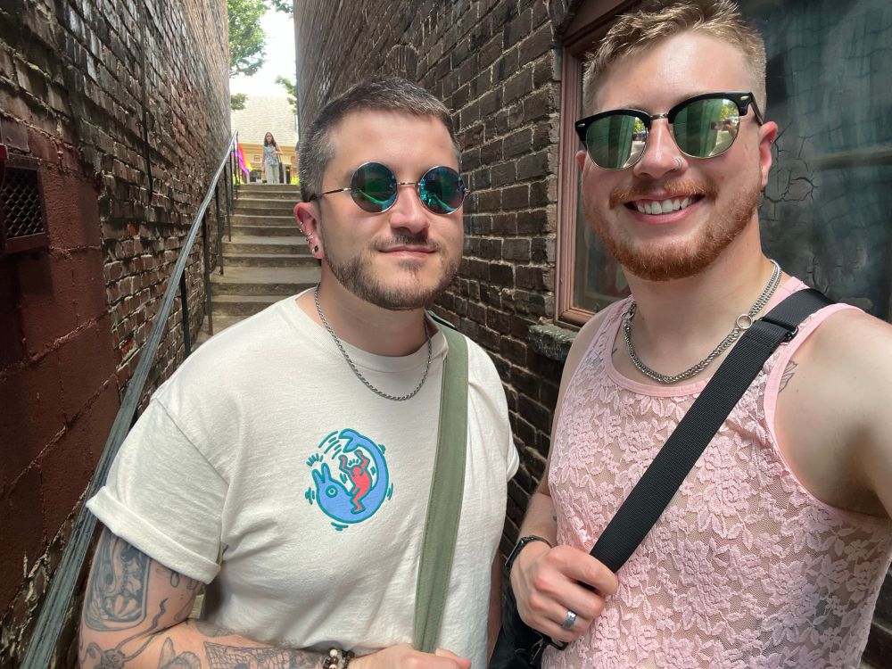 A selfie of James and I in a cute little alleyway while at a pride festival in a small, rural area nearby, 