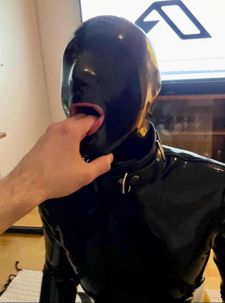 Rubber gimp getting ready to have its throat abused. 