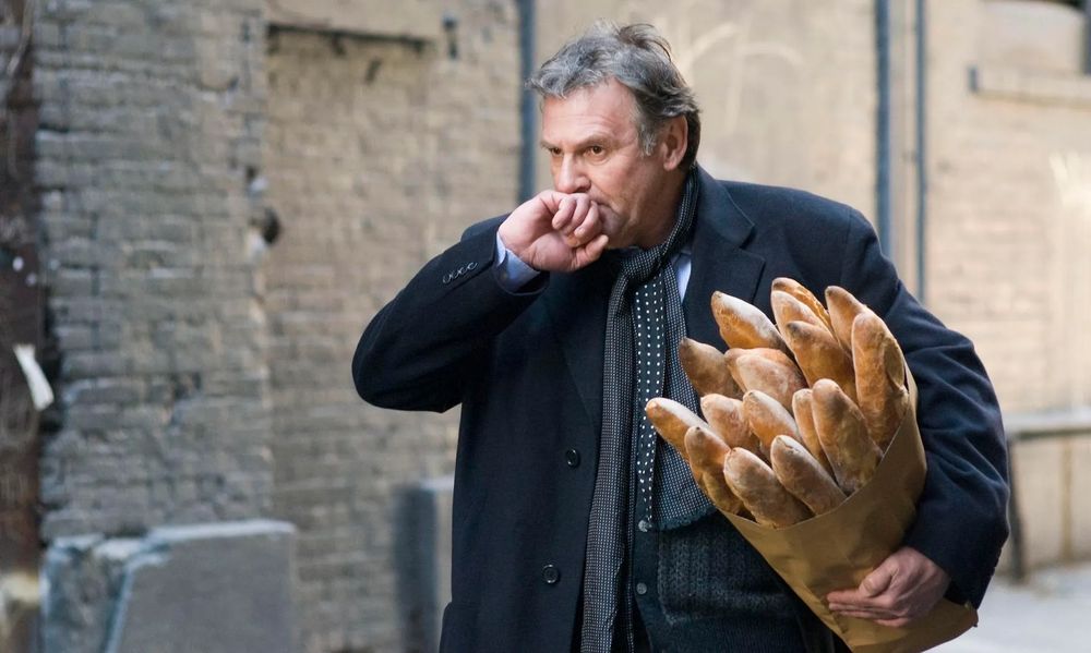 tom wilkinson carrying a huge number of baguettes