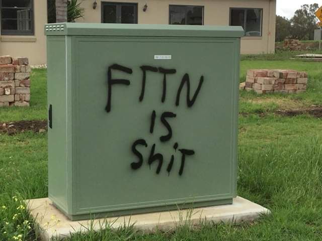 A Vandalized Internet or Electrical box  with the Graffiti "FTTN IS ShiT"