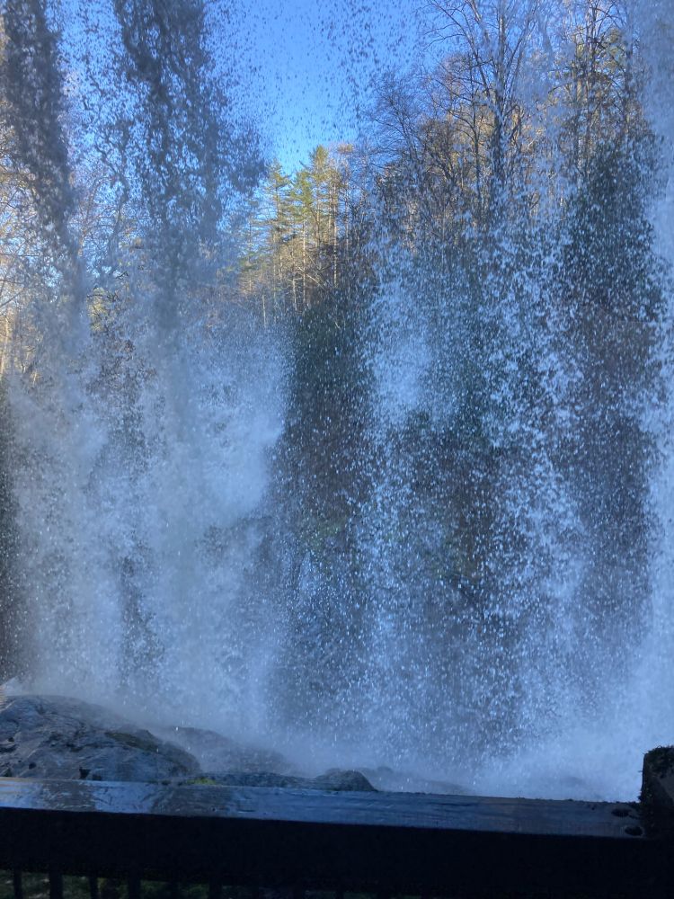 A view from underneath a large waterfall.