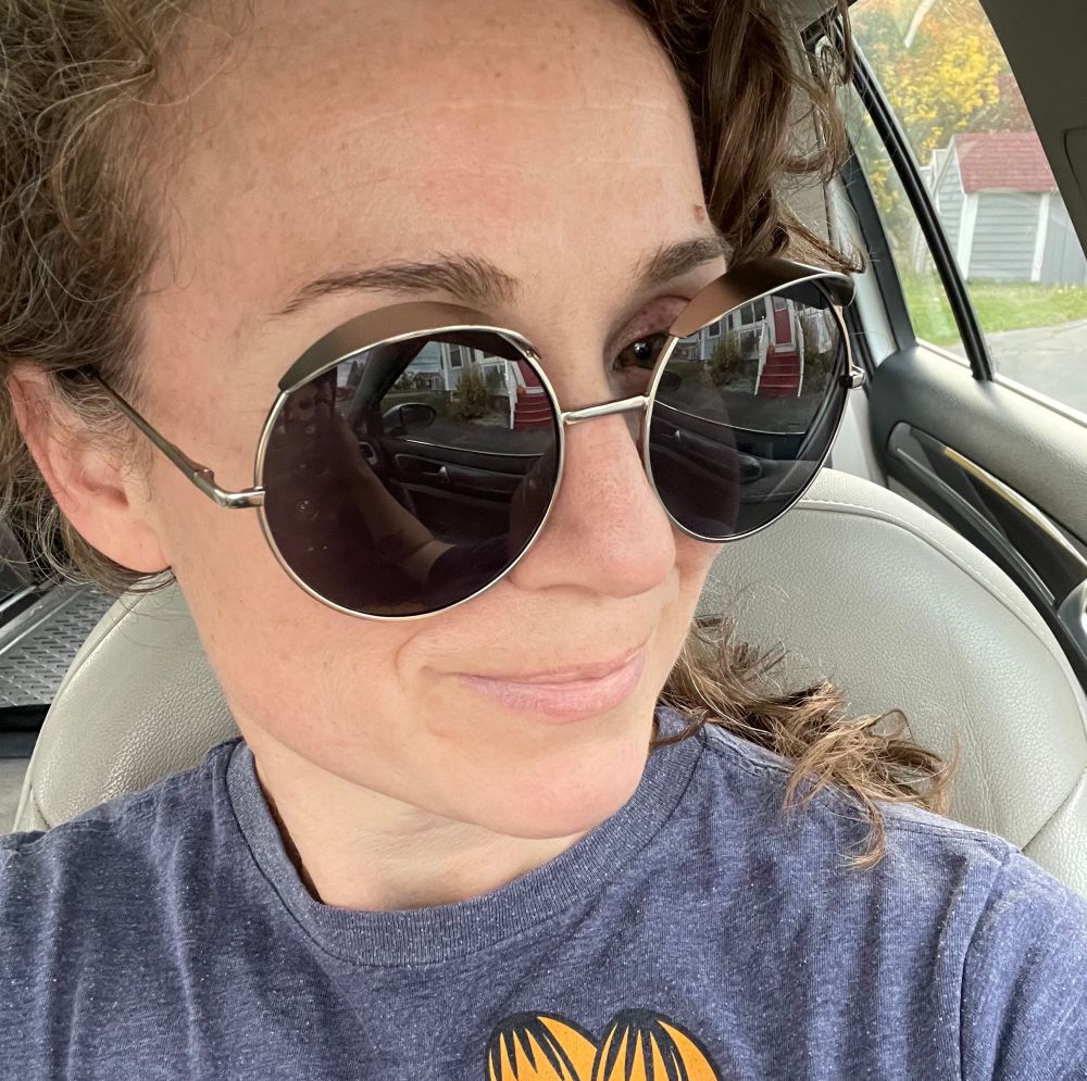 My face wearing large circle sunglasses with metal hoods over each lens.