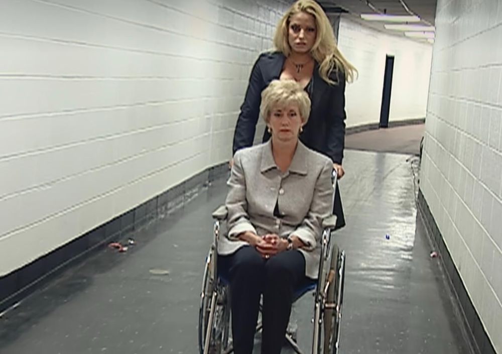 Linda McMahon in a wheelchair as part of a WWE story line. Apparently wrestling is scripted and fake! Who knew. 