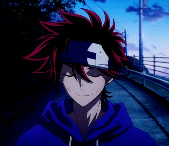 a man with red hair and a bandage on his head is wearing a blue hoodie