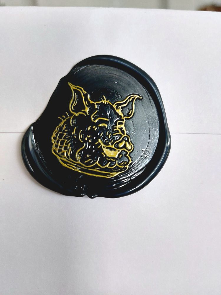 A black wax seal bearing the likeness of a pig.