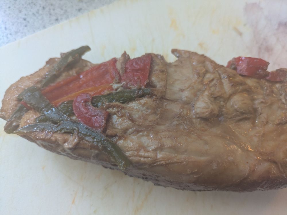 Spicy peppers imprinted on the bottom of the pork tenderloin that roasted on them