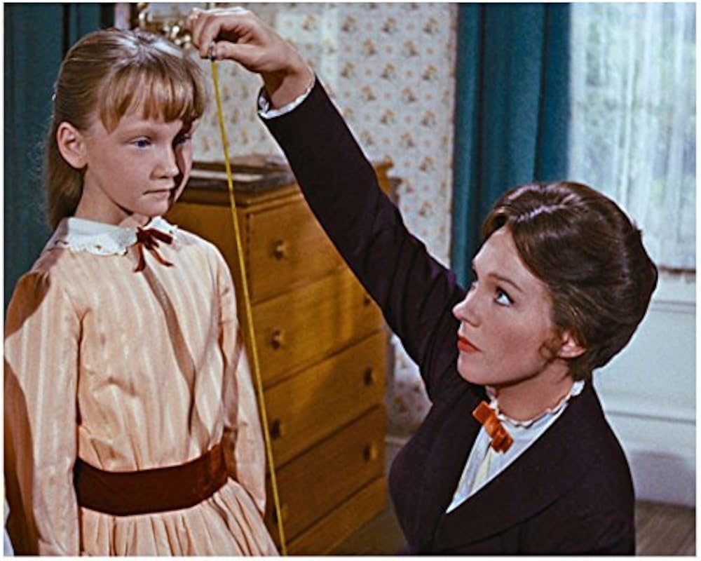 Karen Dotrice as Jane Banks next to Julie Andrews' Mary Poppins in Mary Poppins (1964)