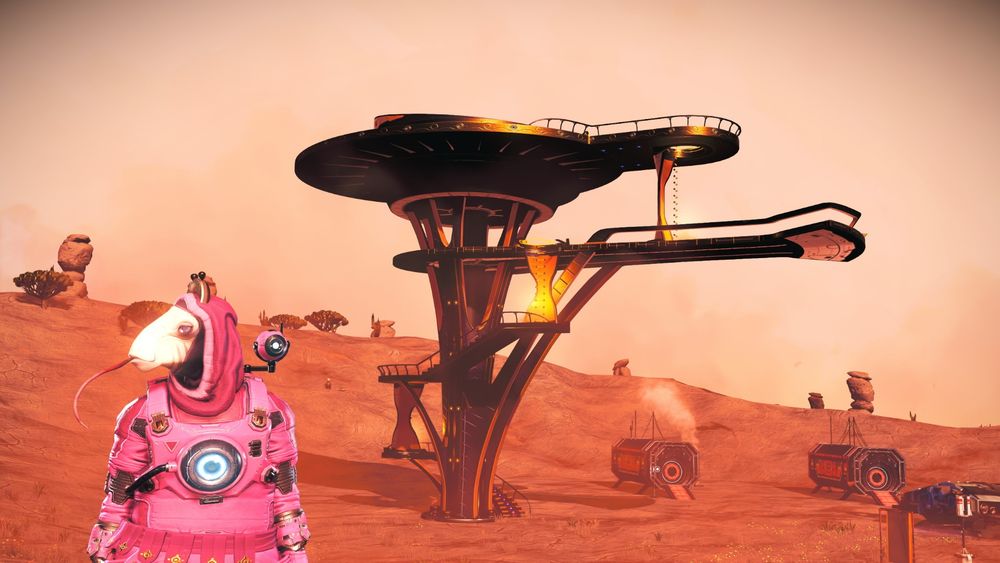 Screenshot from No Man's Sky, showing a pink alien creature in front of a structure 