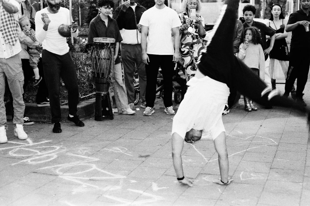 a capoeira dancer does a handstand