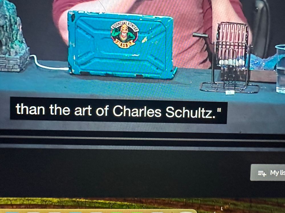 A screenshot of a closed caption wherein the name of American Cartoonist Charles Schulz it spelled S C H U L T Z. There should not be a T. 