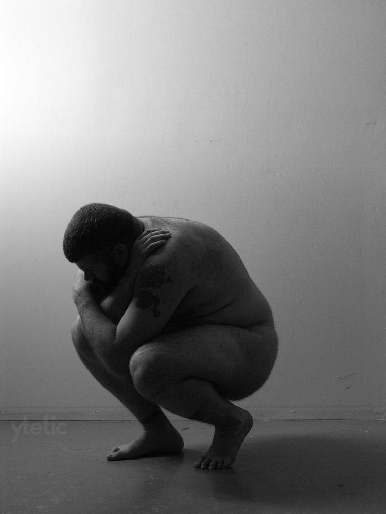 3. Crouched, profile to us, one foot stepped forward.