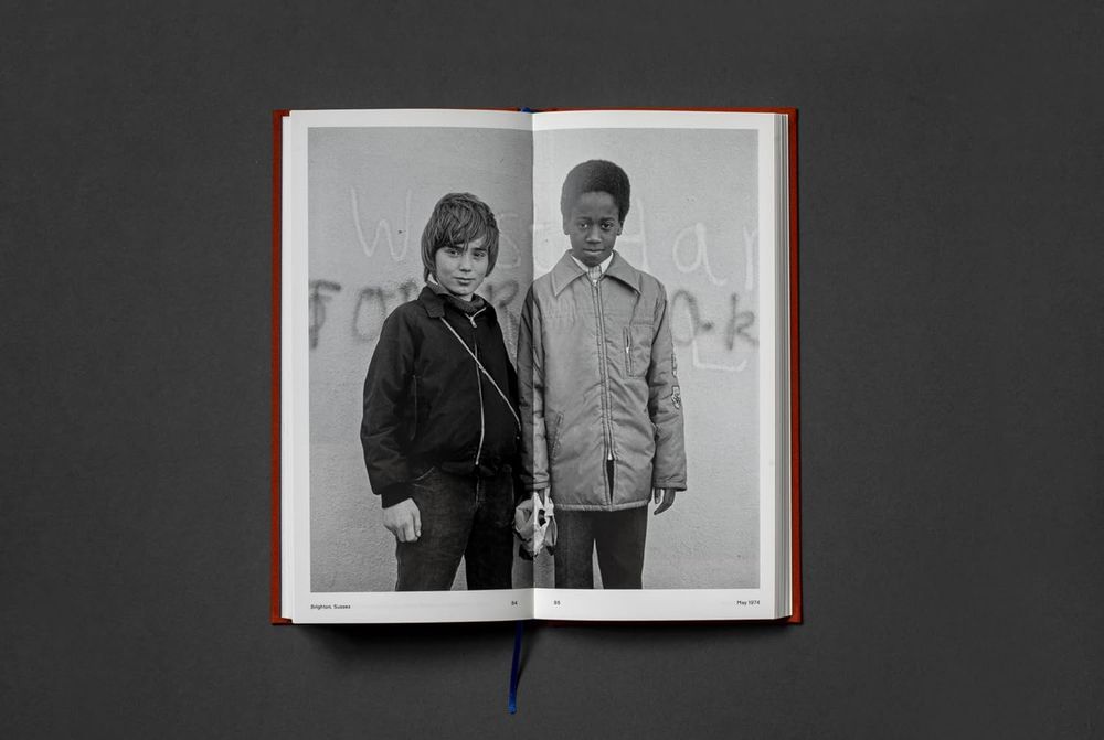 A page from "Book of the Road" by Dan Meadows - a B+W portrait of two boys, printed across a spread of pages. Taken in Brighton, 1974.
