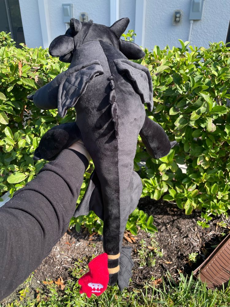 The back of a handmade Toothless plushie