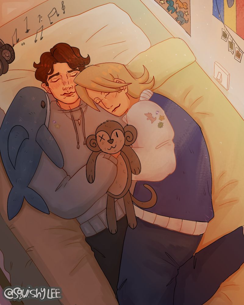 Adam Raki and Nigel Banyai cuddling on a sunlit bed, accompanied with a shark plushie and a monkey plushie. Headphones playing light music in the background, posters and photo strings decorating the walls.