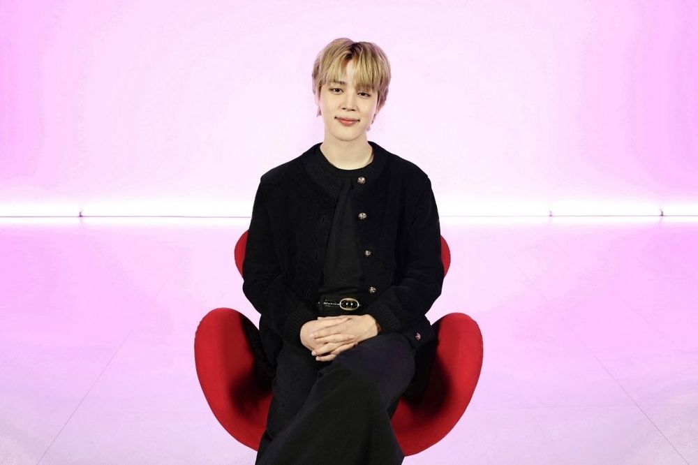 Jimin in a red chair for MUSE promotions