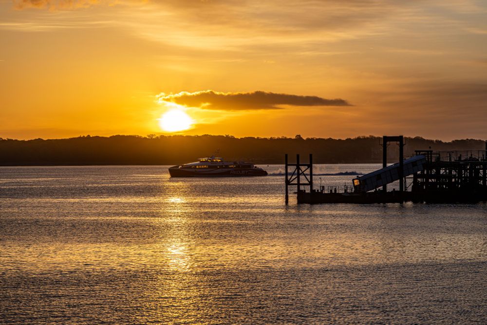 Red Jet 7 passing Hythe Pier at sunrise