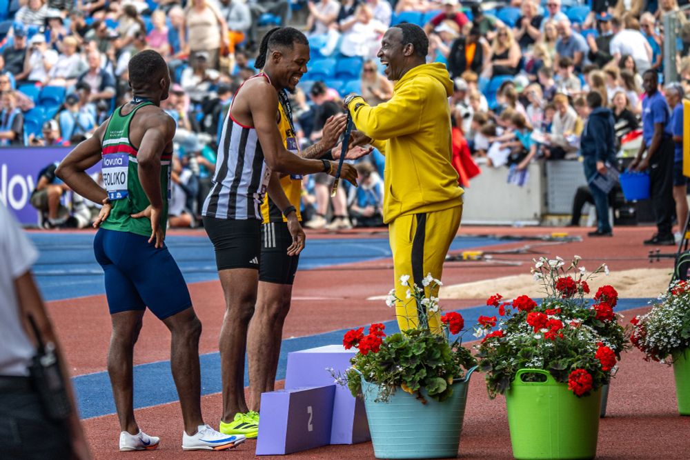 Zharnel Hughes presented with UK gold by Linford Christie