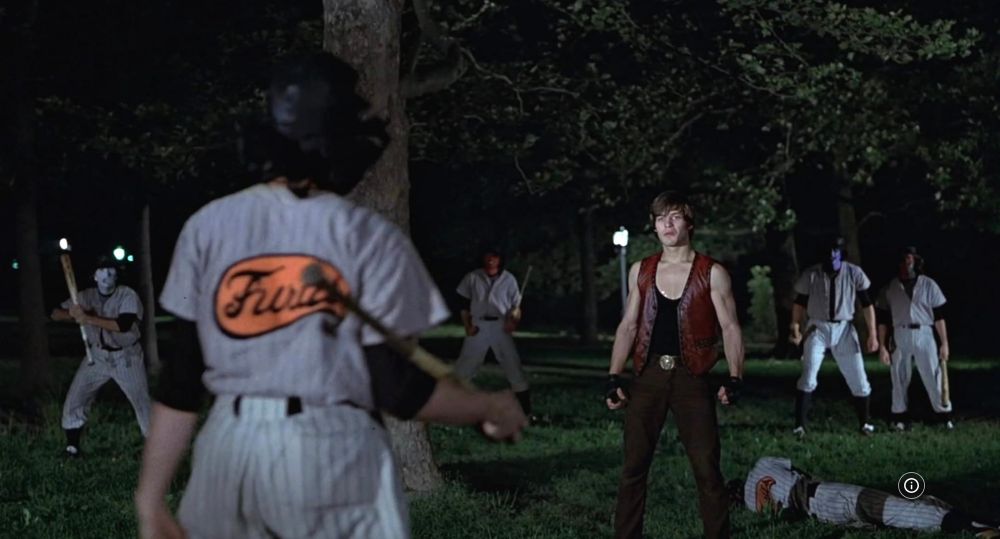 Night. Central Park 1979. A lone Warrior stands surrounded by men in white baseball uniforms, their faces painted grotesquely. These are the Baseball Furies. Can you dig it?