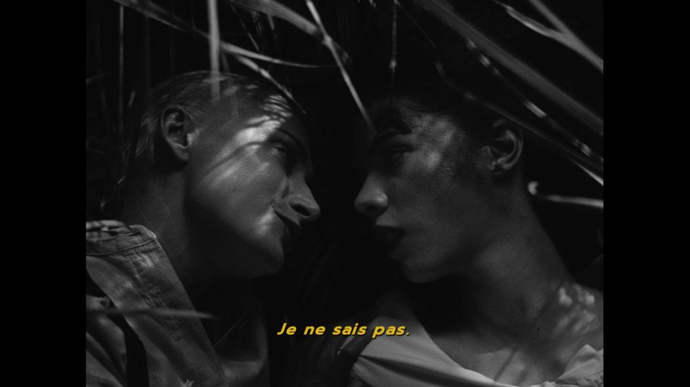 the blonde woman replies "je ne sais pas" (i dont know)