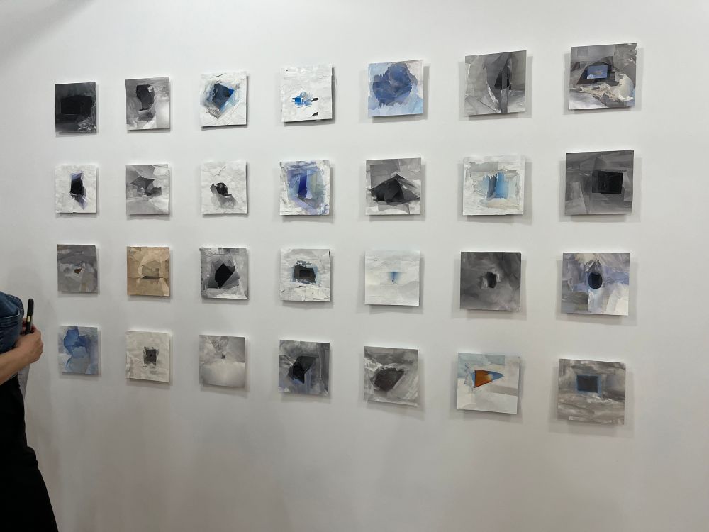 A wall with 28 collages made from one month of skies clipped from the front page of the New York Times 