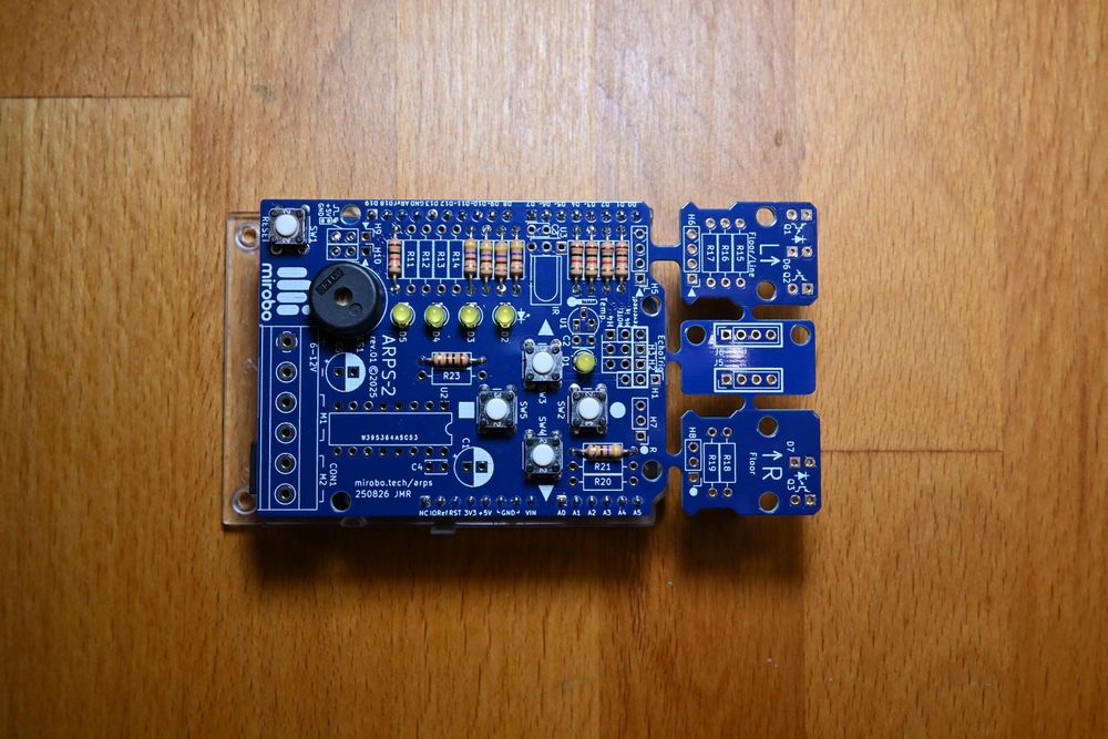 An ARPS-2 circuit assembled in the Educational Starter configuration with four user pushbuttons, four user LEDs, a power LED, a piezo speaker, and a reset button. 