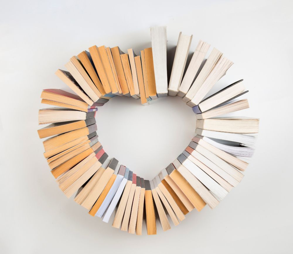A bunch of paperback books arranged in the shape of a heart