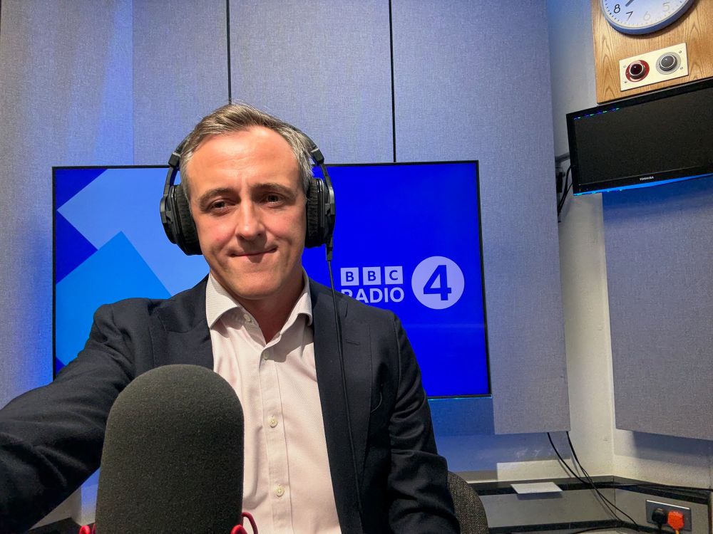 Lewis Atkinson MP in front of microphone in BBC radio 4 studio