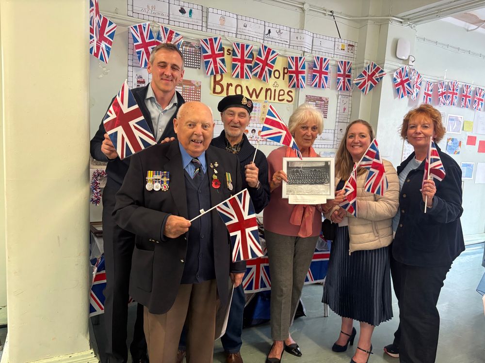 Group of people with union jacks including veteran and Lewis Atkinson MP