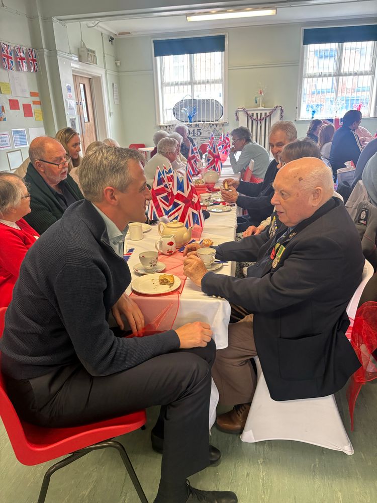 Lewis Atkinson MP talks to Veteran at tea party 